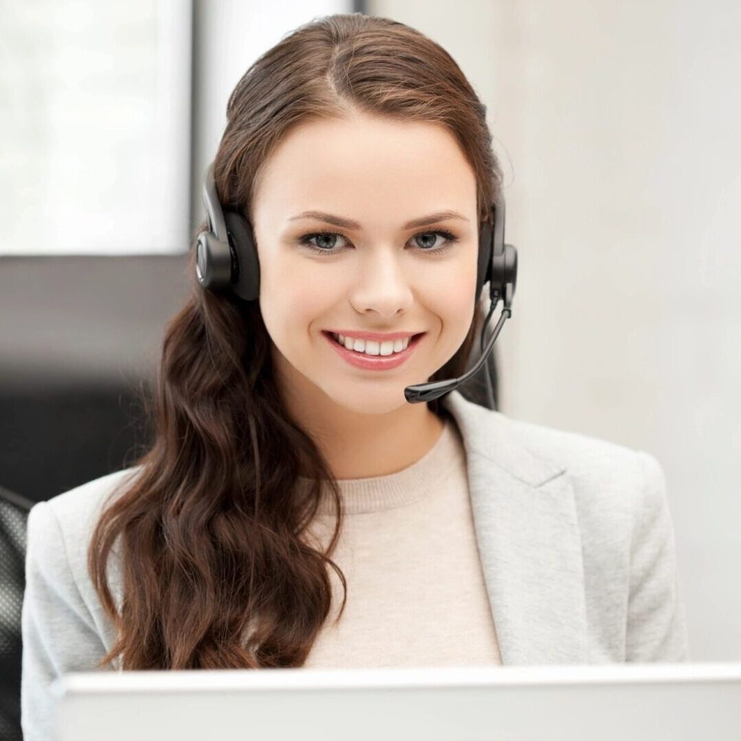 Smiling Female Helpline Operator With Headphones