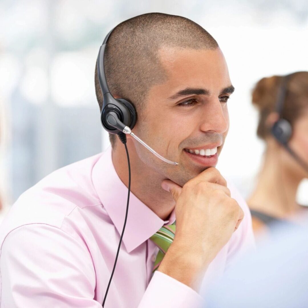 Young Operator Talking to Customers Through Headset