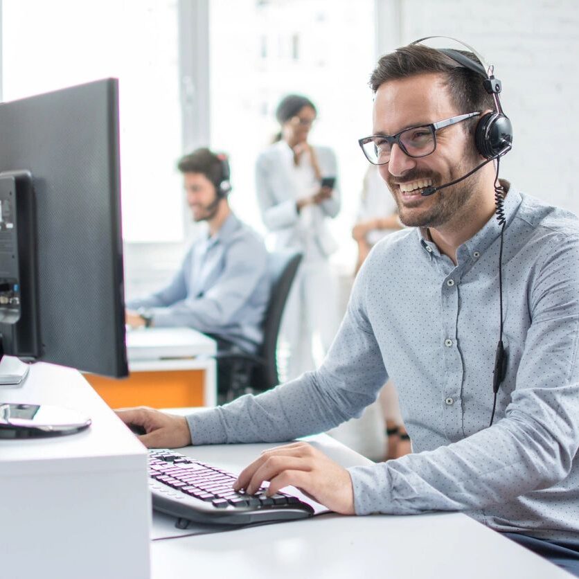 Smiling Customer Support Operator Working in the Office